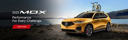 Yellow acura mdx standing on the shore of the lake, with a yellow bike on the roof, on the left white text 2023 MDX Performance For Every Challenge and red button shop now below.